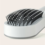 Self cleaning hair brush for women with one-key cleaning, anti-static bristles, and scalp-massage airbag design for smooth, tangle-free, healthy hair.